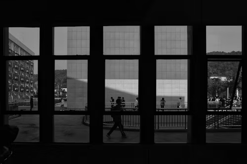 Buildings and people viewed through a multi-pane window